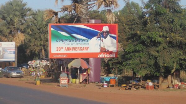 A giant billboard of President Yahya Jammeh, of the Gambia, sits on an empty street in Banjul. - سبوتنيك عربي