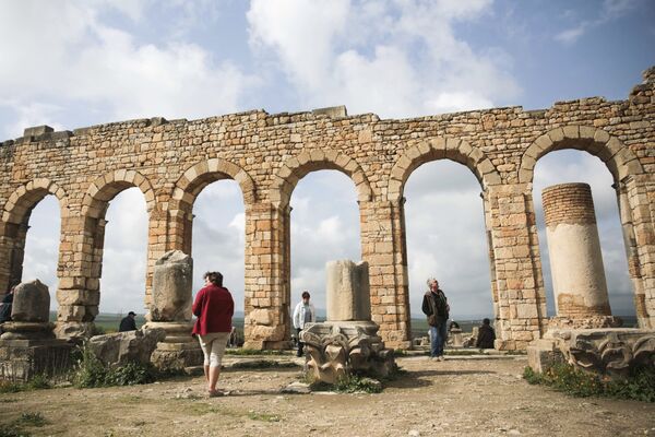 سياح متجمعون حول أقواس بازيليكا، وهي من أشهر الآثار الرومانية بالقرب من مكناس، المغرب 24 فبراير/ شباط 2017 - سبوتنيك عربي