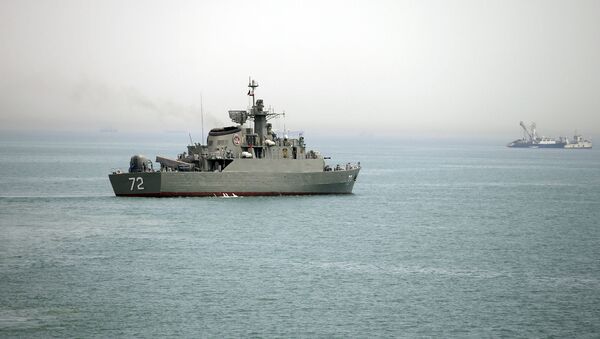 In this Tuesday, April 7, 2015, file photo released by the semi-official Fars News Agency, Iranian warship Alborz, foreground, prepares before leaving Iran's waters, at the Strait of Hormuz - سبوتنيك عربي