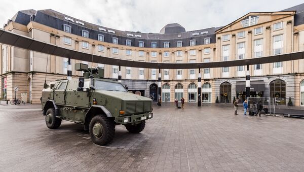 A Belgian Army vehicle is parked on the almost deserted square in front of the main train station in the center of Brussels on Sunday, Nov. 22, 2015. - سبوتنيك عربي