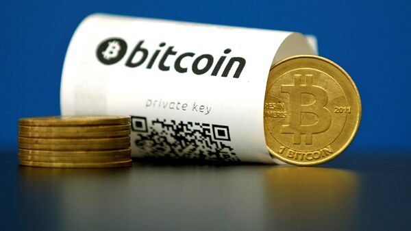 A Bitcoin (virtual currency) paper wallet with QR codes and a coin are seen in an illustration picture taken at La Maison du Bitcoin in Paris, France May 27, 2015 - سبوتنيك عربي