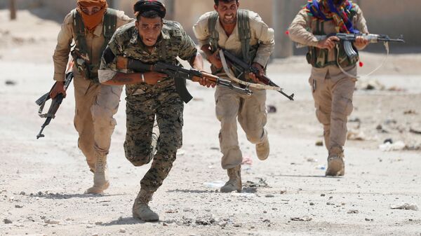 مقاتلون أكراد من وحدات حماية الشعب يجرون في إحدى شوارع مدينة الرقة، سوريا 3 يوليو / تموز 2017. - سبوتنيك عربي