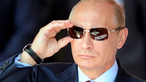 File photo: Vladimir Putin adjusts his sunglasses as he watches an air show during MAKS-2011, the International Aviation and Space Show, in Zhukovsky, outside Moscow, on August 17, 2011 - سبوتنيك عربي