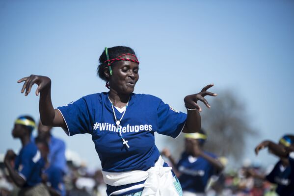 لاجئون موزامبيقيون برقصون موشونغويو التقليدي خلال احتفالات يوم العالمي للاجئين في مخيم تونغوغارا للاجئين في شيبينج بمقاطعة مانيكالاند، زيمبابوي 2 أغسطس/ آب 2017 - سبوتنيك عربي