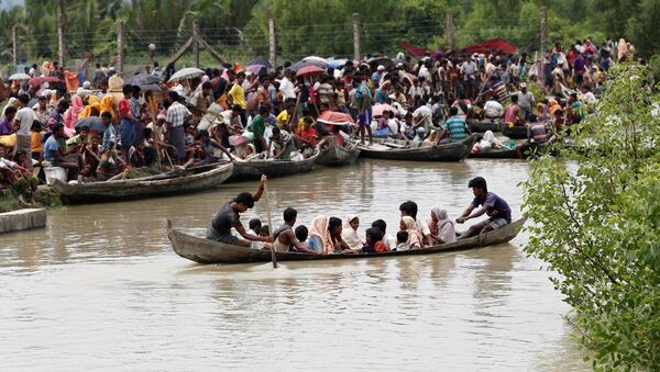 A boat carrying Rohingya refugees is seen leaving Myanmar through Naf river while thousands other waiting in Maungdaw, Myanmar, September 7, 2017 - سبوتنيك عربي