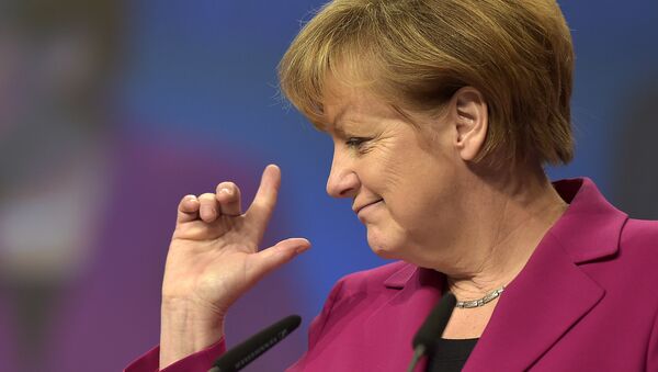 German Chancellor and chairwoman of the German Christian Democrats, CDU, Angela Merkel, points with her fingers during a visit to the convention venue prior to the 27. party convention in Cologne, Germany, Monday, Dec. 8, 2014. - سبوتنيك عربي
