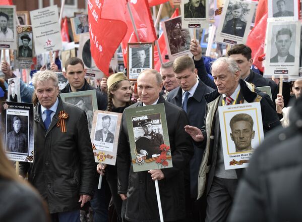 الرئيس فلاديمير بوتين أثناء مشاركته المواطنين لمسيرة الفوج الخالد في الذكرى الـ72 لعيد النصر في الحرب الوطنية العظمى في الساحة الحمراء بموسكو، روسيا 9 مايو/ أيار 2017 - سبوتنيك عربي