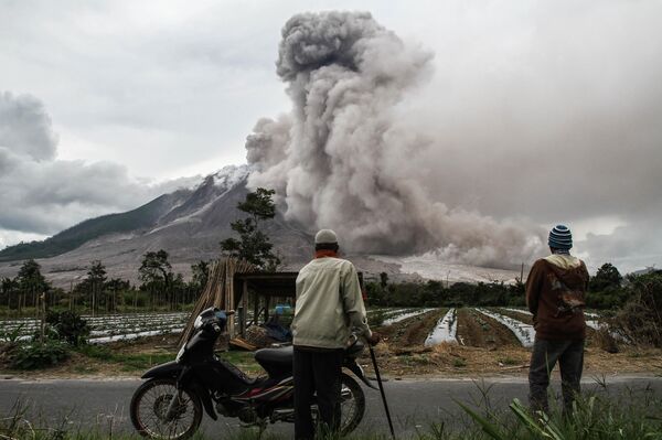 مواطنون يراقبون ثوران بركان سينابونغ في كارو، شمال جزيرة سومطرة، إندونيسيا 24 أكتوبر/ تشرين الأول 2017 - سبوتنيك عربي