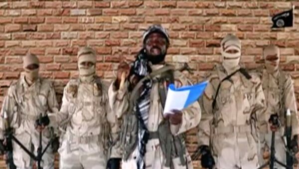 زعيم جماعة من فصائل جماعة بوكو حرام، أبو بكر شيكاو يتحدث أمام الحراس في مكان مجهول في نيجيريا - سبوتنيك عربي