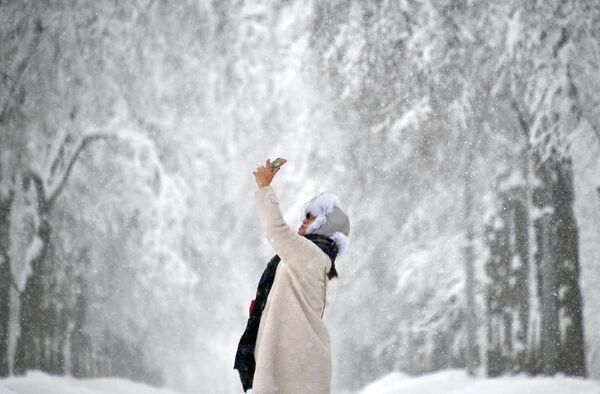 فتاة تلتقط صورة سيلفي لها في حديقة فوروبيوفي غوري (تل الدويري) خلال عاصفة القرن في موسكو - سبوتنيك عربي