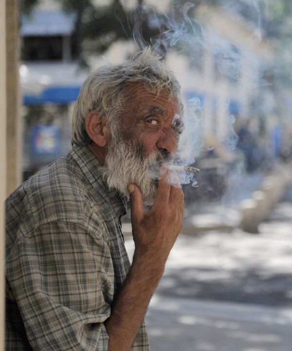 أحد سكان مدينة مونبلييه في فرنسا يدخن في أحد شوارع المدينة - سبوتنيك عربي