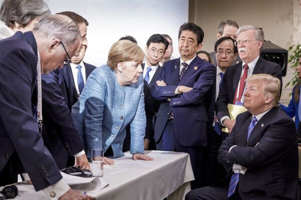مستشارة ألمانيا أنجيلا ميركل خلال حديثها مع الرئيس الأمريكي دونالد ترامب في قمة مجموعة السبع الكبار في كيبيك، كندا 9 يونيو/ حزيران 2018 - سبوتنيك عربي