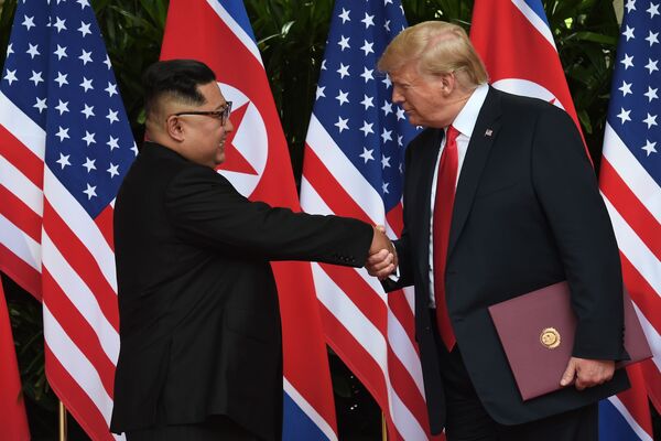 الرئيس الأمريكي دونالد ترامب والزعيم الكوري الشمالي كيم جونغ أون يتصافحان مع نهاية القمة التاريخية الأمريكية الكورية في سنغافورة، 12 يونيو/ حزيران 2018 - سبوتنيك عربي