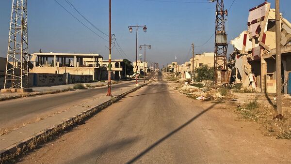 أهالي بلدة علما، في محافظة درعا، يعودون إلى منازلهم بعد تحريرها من مسلحي تنظيم داعش الإرهابي - سبوتنيك عربي
