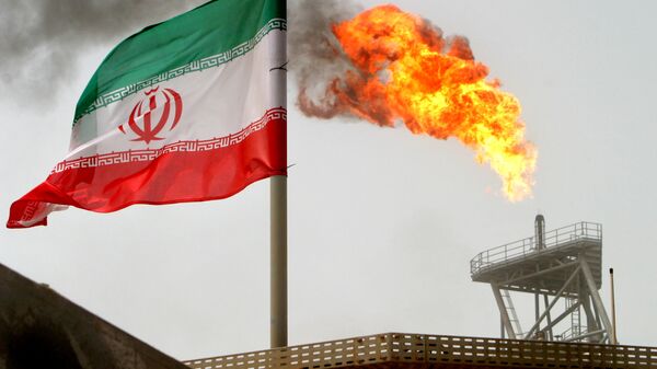علم إيران على خلفية توهج ناري لغاز في حقل سوروش النفطي في الخليج الفارسي، إيران 25 يوليو/ تموز 2018 - سبوتنيك عربي