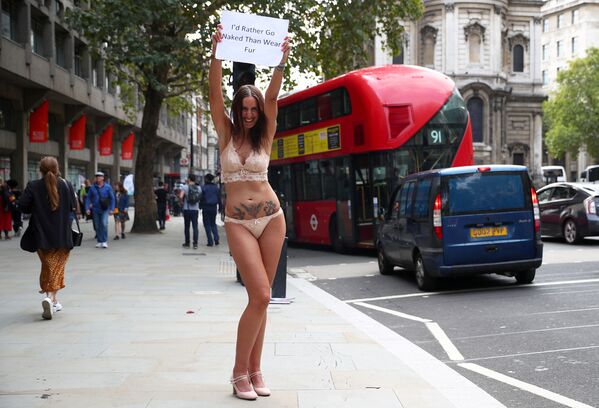 فتاة تحمل لافتة أفضل أن أكون عراة على أن أرتدي الفرو، في إطار حملة ضد استخدام جلود وفرو الحيوانات لصناعة الملابس، خلال أسبوع الموضة في لندن، بريطانيا 15 سبتمبر/ أيلول 2018 - سبوتنيك عربي