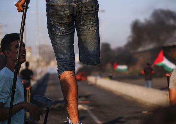 أحد المشاركين الفلسطينيين في احتجاجات معبر إيريز، على الحدود بين قطاع غزة وإسرائيل 26 سبتمبر/ أيلول 2018 - سبوتنيك عربي