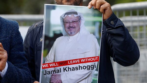 متظاهر يحمل صورة للصحفي السعودي جمال خاشقجي أثناء احتجاج أمام القنصلية السعودية في اسطنبول - سبوتنيك عربي