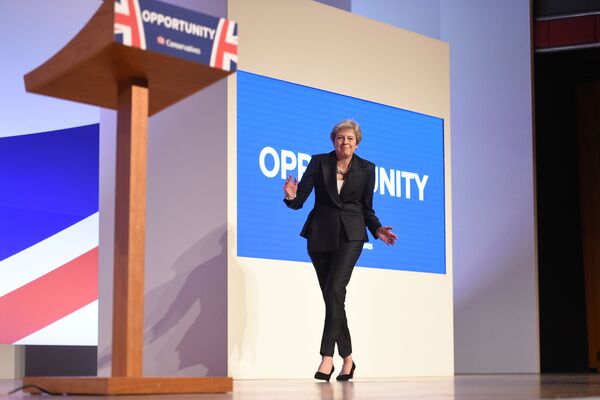 رئيسة الوزراء البريطانية تيريزا ماي ترقص على أنغام أغنية Dancing Queen للفرقة الغنائية ABBA، لدى خروجها إلى مؤتمر صحفي Conservative Party 2018 في برمنغهام، 3 أكتوبر/ تشرين الأول 2018 - سبوتنيك عربي