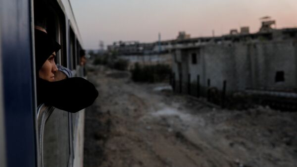 امرأة تطل من نافذة قطار في ضواحي دمشق، سوريا  12 سبتمبر/ أيلول 2018 - سبوتنيك عربي