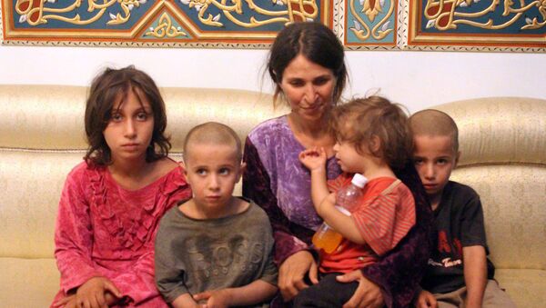 سيدة سورية من مدينة السويداء مختطفة مع أولادها عند التنظيم الإرهابي داعش - سبوتنيك عربي