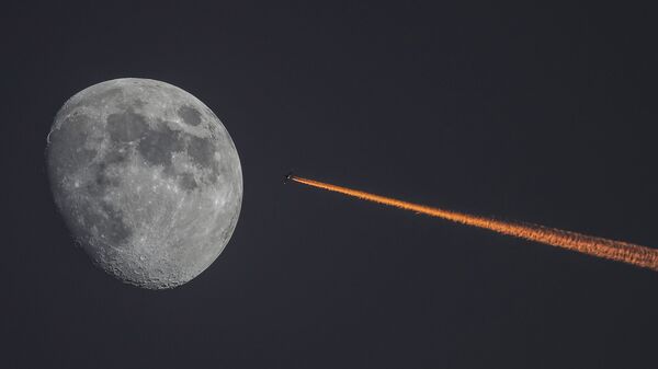 القمر والطائرة على خلفية غروب الشمس - سبوتنيك عربي
