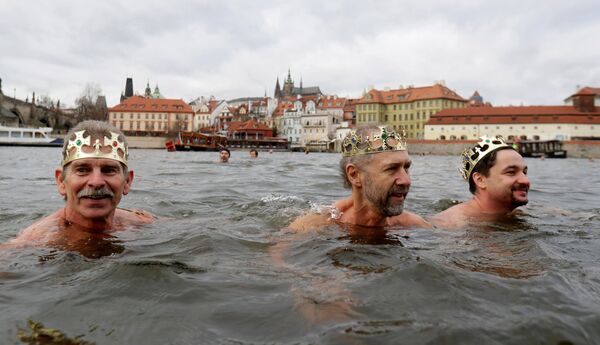 مشاركون يشاركون في السباحة التقليدية الملوك الثلاثة للاحتفال بعيد الغطاس في نهر فلتافا في براغ، جمهورية التشيك، 6 يناير/ كانون الثاني 2019 - سبوتنيك عربي