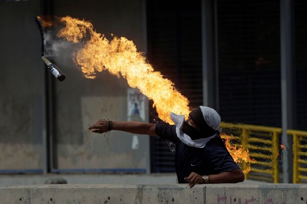متظاهر يرمي زجاجة كوكتيل مولوتوف خلال احتجاجات ضد رئيس هندوراس خوان أورلاندو هيرنانديز، خارج جامعة هندوراس الوطنية في تيغوسيغالبا، هندوراس 28 يناير/ كانون الثاني 2019 - سبوتنيك عربي
