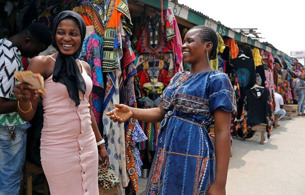 بائعات الملابس يتبادلن المال في مارينا، في العاصمة التجارية في نيجيريا لاغوس، نيجيريا في 11 فبراير/ شباط 2019 - سبوتنيك عربي