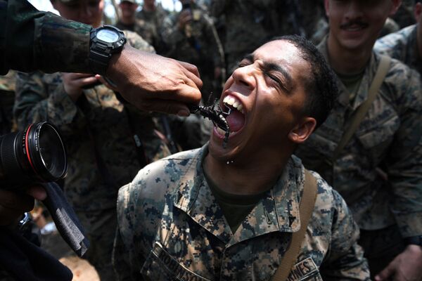 ابتسامة أحد مشاة البحرية الأمريكية يأكل عقرباً، خلال التدريبات العسكرية المشتركة كوبرا غولد (Cobra Gold) في مقاطعة تشونبوري الساحلية في 19 فبراير/ شباط 2018. - سبوتنيك عربي