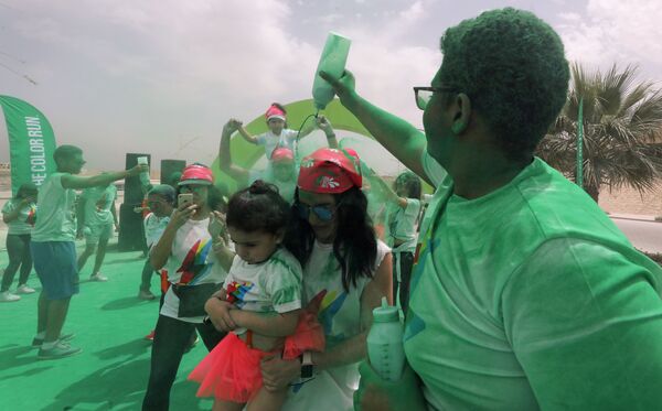قام متطوعون بصب مسحوق أخضر في أول مسابقة الألوان في الجيزة، مصر في 13 أبريل/ نيسان 2019 - سبوتنيك عربي