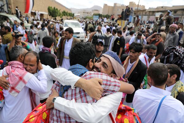 معتقلون يحضنون أقاربهم بعد إطلاق سراحهم من قبل الحوثيين خارج سجن صنعاء المركزي، اليمن 30 سبتمبر 2019 - سبوتنيك عربي