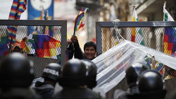 عناصر الشرطة تغلق الطريق على أنصار الرئيس السابق يفو موراليس بالقرب من مبنى الكونغرس في لاباز، بوليفيا 12 نوفمبر 2019 - سبوتنيك عربي