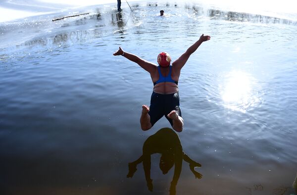امرأة تقفز إلى مياه بحيرة متجمدة في حديقة شينيانغ في مدينة لياونينغ شمال الصين، 2 ديسمبر 2019 - سبوتنيك عربي