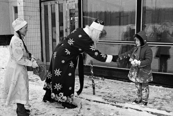 بابا نويل و سنيغوروتشكا يهنئان طفلا لة برأس السنة في أحد شوارع موسكو، عام 1985 - سبوتنيك عربي