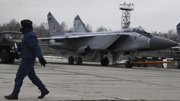 فني يسير إلى جوار طائرة من طراز MiG-31 أثناء رحلات تدريب لطائرات Su-35S في روسيا - سبوتنيك عربي
