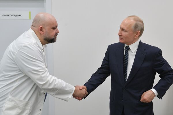 الرئيس فلاديمير بوتين يشكر دينيس بروستينكو، كبير أطباء مستشفى كوموناركا، المخصص لاستقبال المصابين بـكورونا على تنظيم العمل، موسكو،  24 مارس 2020 - سبوتنيك عربي