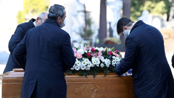 عمال المقبرة وموظفو خدمة الجنازات ينقلون تابوت شخص توفي بسبب فيروس كورونا في بيرغامو، إيطاليا - سبوتنيك عربي