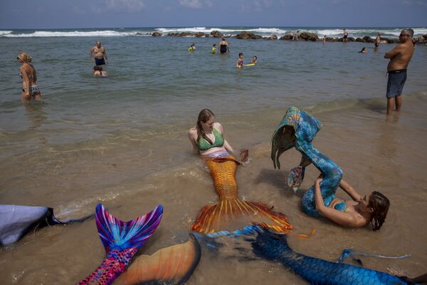أعضاء جماعة حوريات البحر الإسرائيلية يرتدون ذيل عروس البحر على شاطئ البحر في بات يام، بالقرب من تل-أبيب، إسرائيل، 23 مايو/ أيار 2020. - سبوتنيك عربي
