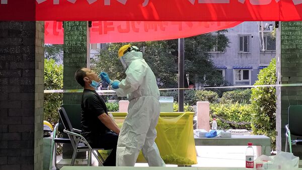 رجل يخضع لاختبار كورونا في موقع اختبار مؤقت في مجمع سكني بعد تفشي جديد لمرض فيروس كورونا في بكين - سبوتنيك عربي