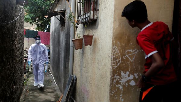 موظف في القطاع الصحي يتفقد المواطنين لاجراء اختبار فيروس كورونا في مومباي، الهند، 1 يوليو 2020. - سبوتنيك عربي
